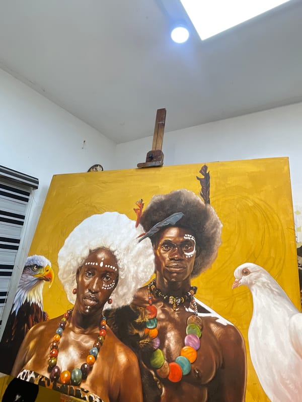 Artist works on traditional portrait painting in Ado studio