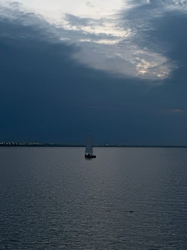 Sailboat on a Kokshetau lake at dusk