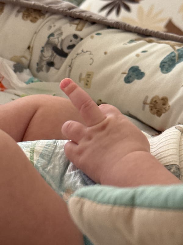 Baby rests on bed in Bar, Montenegro