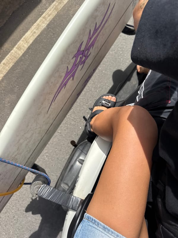 Surfboard strapped to a scooter, ready to hit the Sri Lanka coast