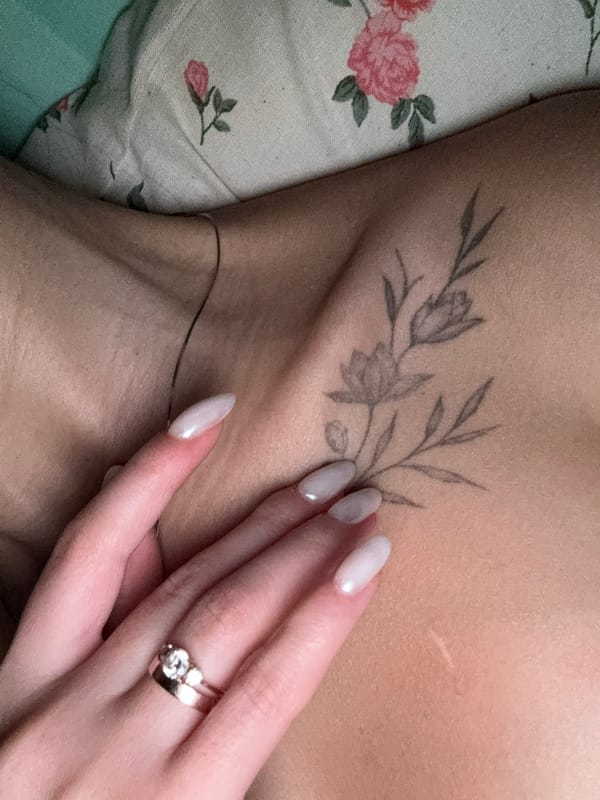 Person shows floral tattoo in portrait photo in Chaikovsky