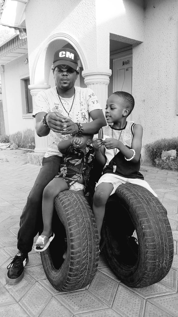 Man and boys play with tires in Nigeria