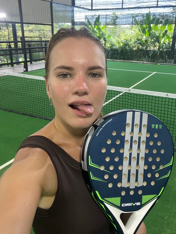 Woman takes playful selfie on padel court in Indonesia