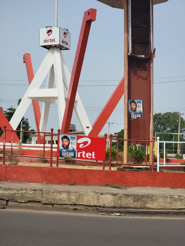 Airtel sign, political posters spotted roadside in Barnawa, Nigeria