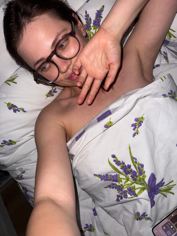 Person rests in lavender-patterned bedding in Hungarian village