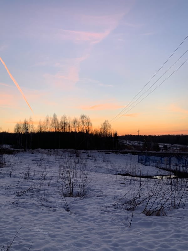 Winter sunset over snowy Russian oil fields