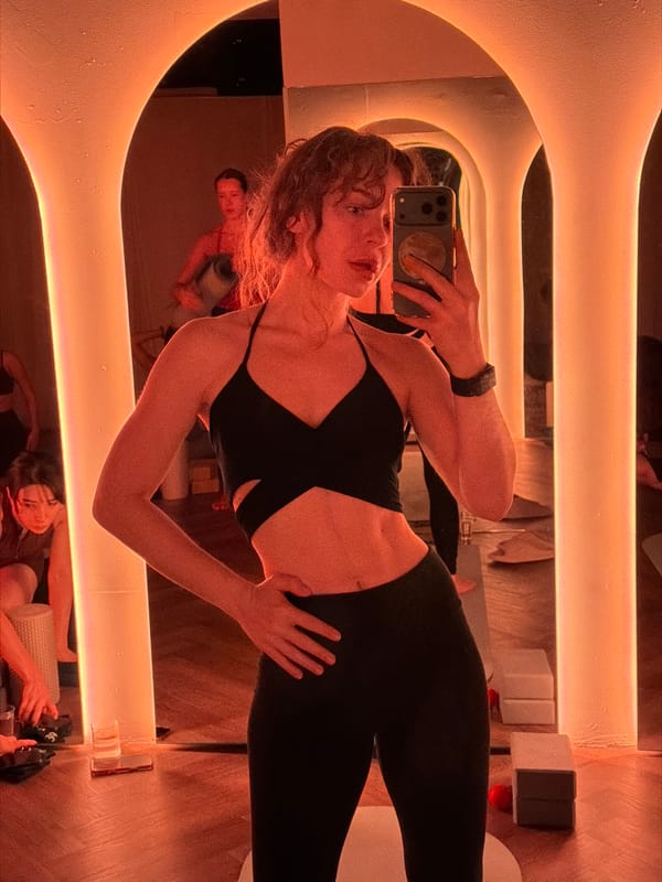 Woman takes mirror selfie in Moscow fitness studio