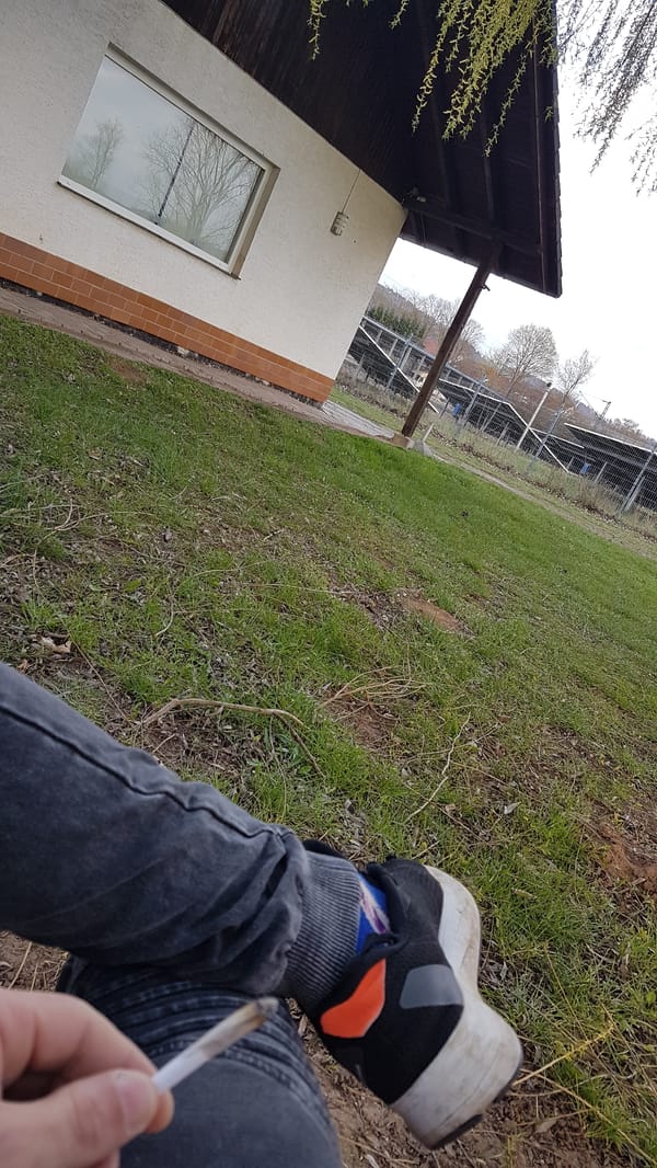 Person photographed outdoors in Heinebach holding lit object