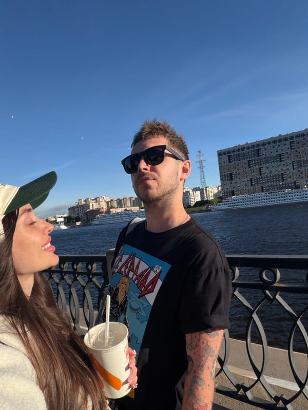 Couple enjoys waterfront view with ship in Shushary