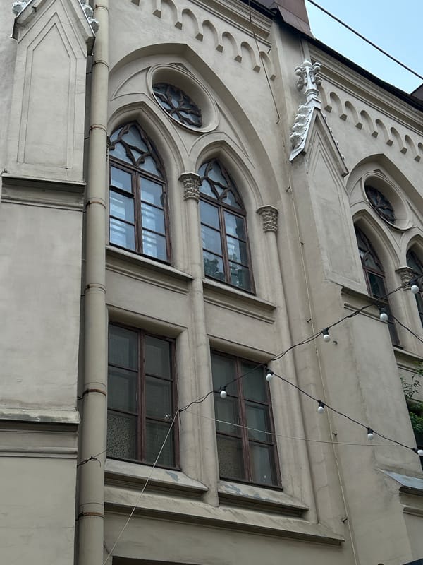 Woman in pinstripe suit observed near historic Saint Petersburg buildings
