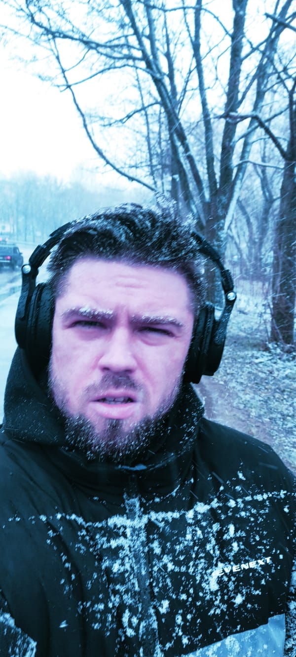 Man photographed in snowfall wearing headphones in Fryazino