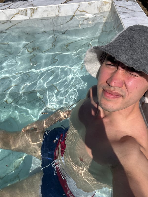 Man in sauna hat enjoys pool time in Kazan