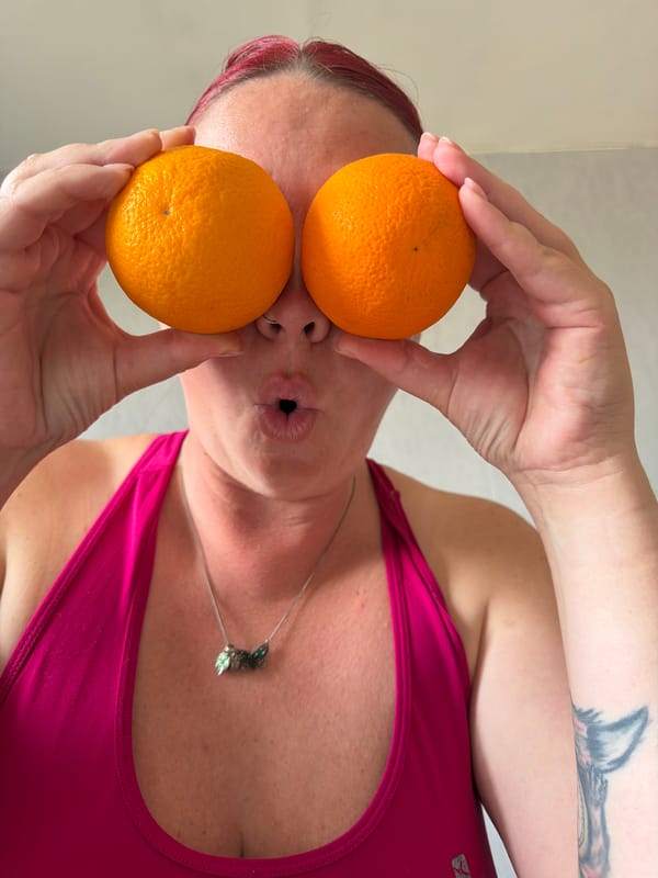 Woman poses playfully with oranges in Chaikovsky photo session
