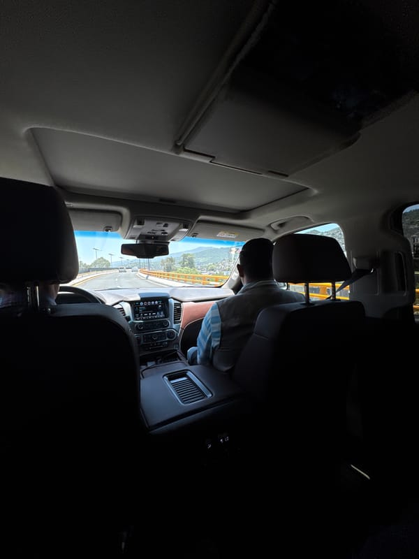 Passenger documents sunny afternoon drive on Mexico City winding road