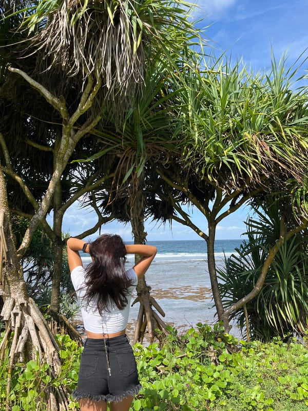 Woman poses for sunrise photo session at Kuta Selatan coast
