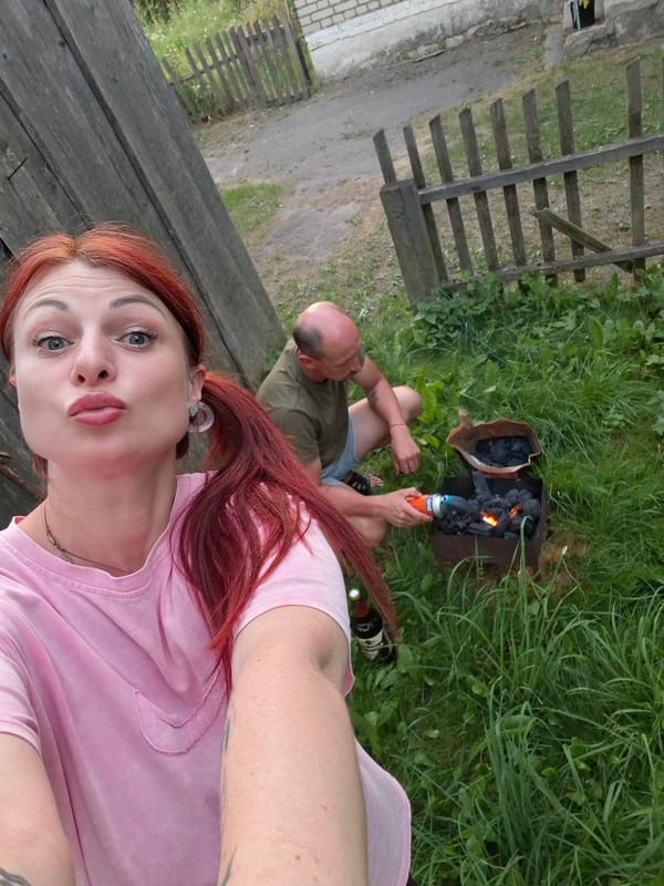 Backyard cookout in rural Belarus, complete with a Sphynx cat