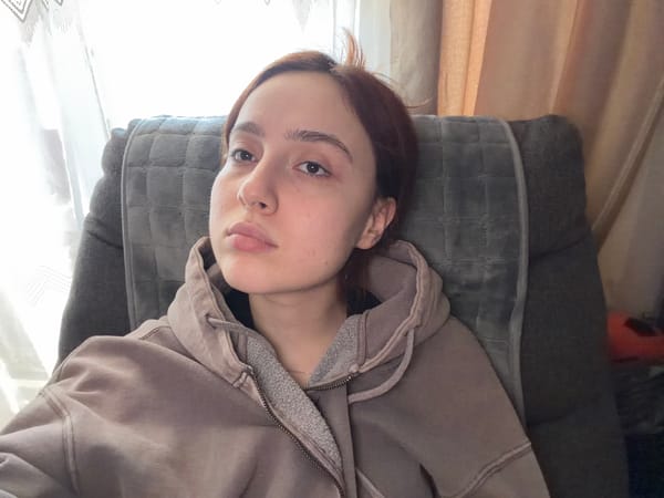 Woman rests on cushion in Strasbourg home setting