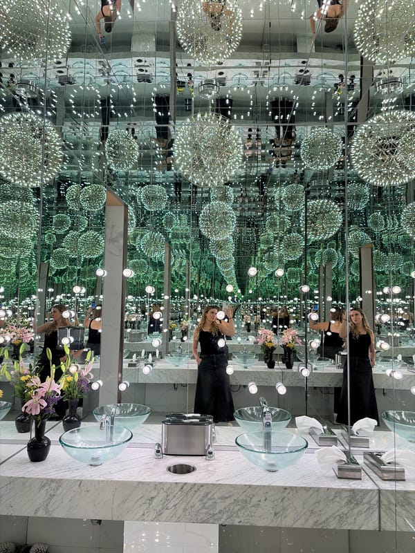 Woman takes selfies in infinity mirror bathroom