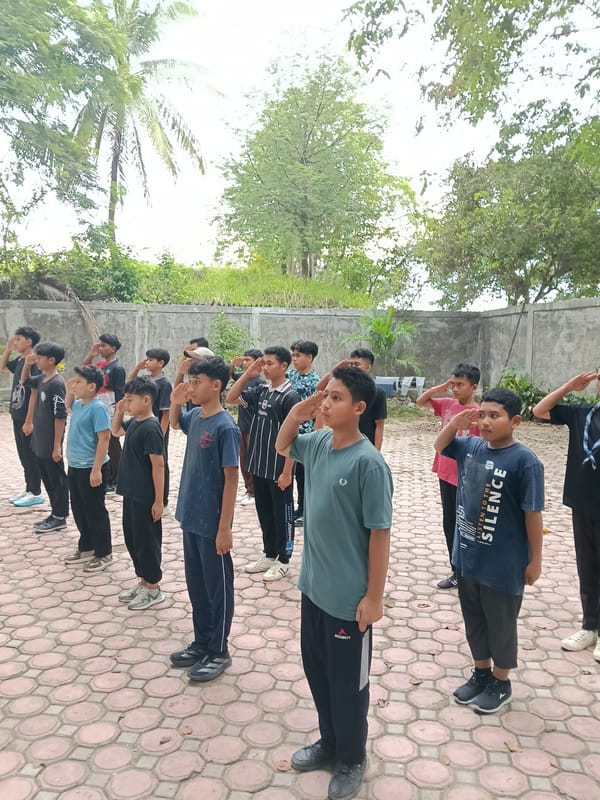Students gather in formation on paved surface in Lhokseumawe