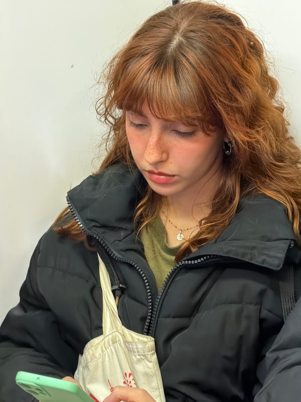 Young woman with phone spotted resting in Madrid