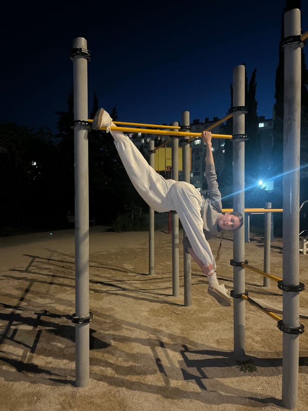 Woman exercises, photographs K-pop cutout in evening Sevastopol session