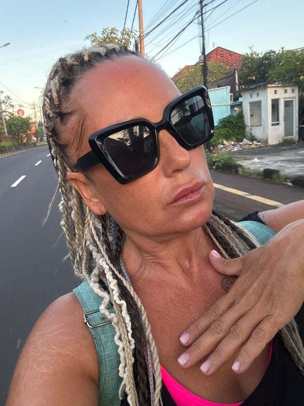 Woman photographs herself outdoors in Kuta Selatan, Indonesia