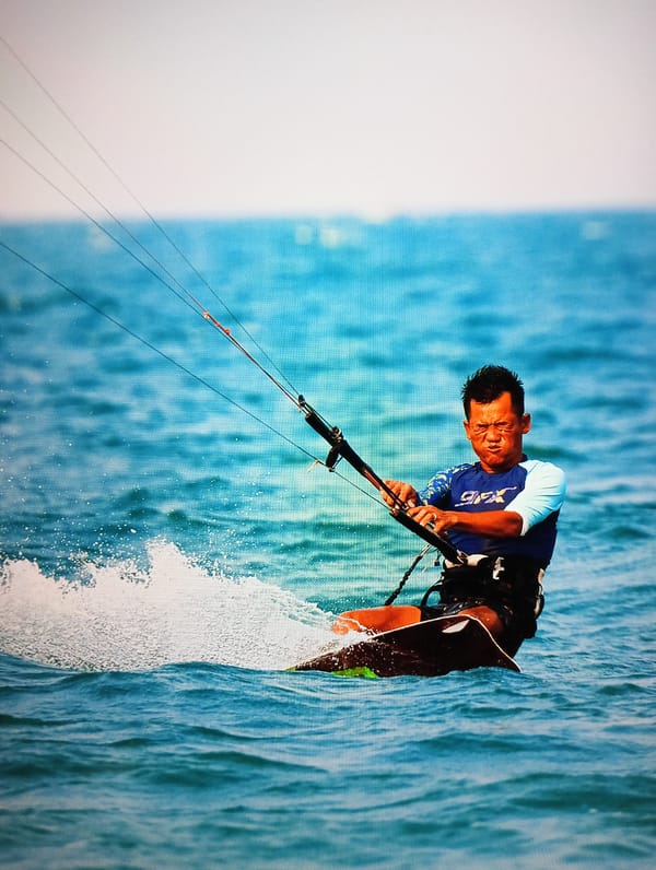 Tourists enjoy beach activities, kitesurfing in Nha Trang