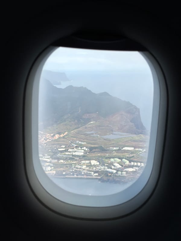 Airplane passenger captures foggy mountain view over Caniço, Portugal
