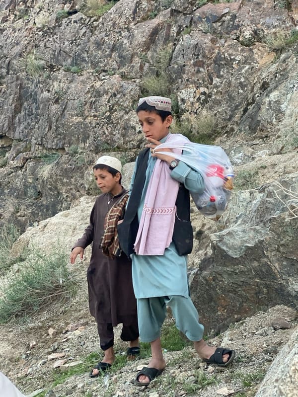 Community gathering by river in Mansurabad, Afghanistan draws locals