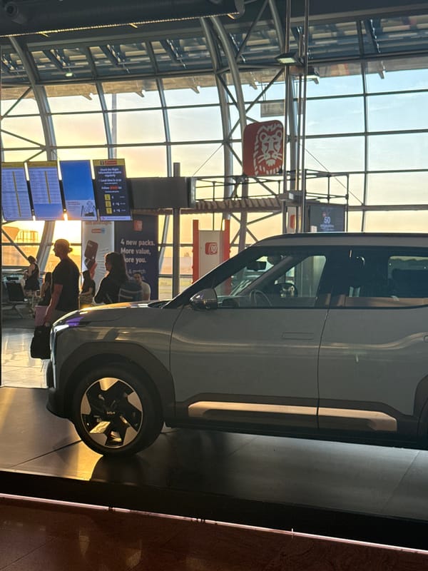 Kia EV6 on display at Brussels Airport terminal at sunset
