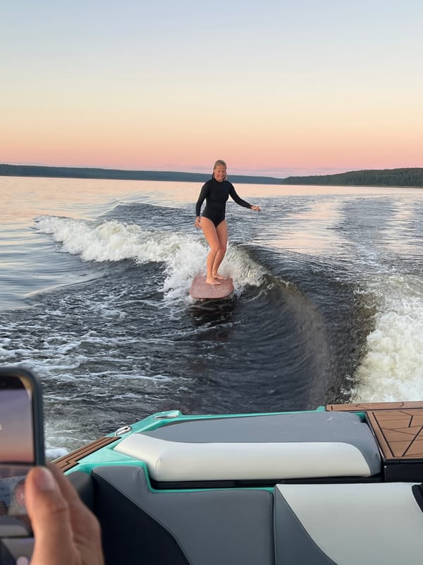 Wake surfing session on a Gromovo lake at sunset