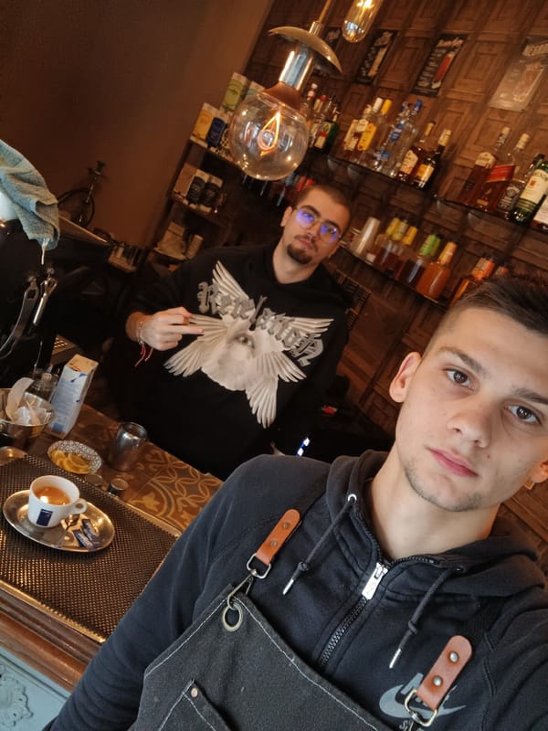Two men photographed together at bar or café