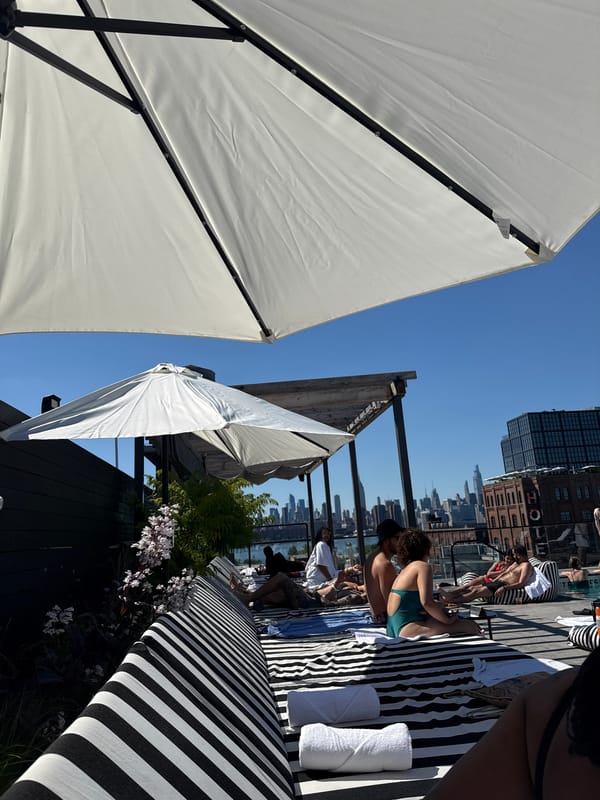 People relax at sun-drenched NYC rooftop pool overlooking skyline