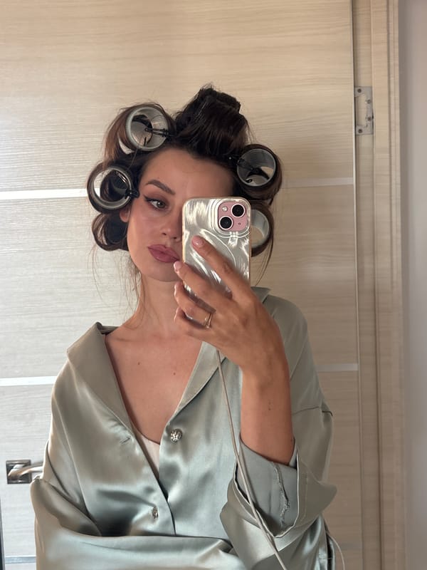 Woman takes mirror selfies with hair rollers in Krasnoyarsk