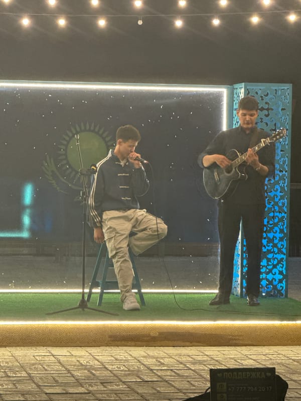 Outdoor stage performance in Pavlodar under Kazakh flag imagery