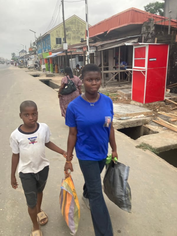 Ordinary street life documented across Aba, Nigeria during overcast afternoon
