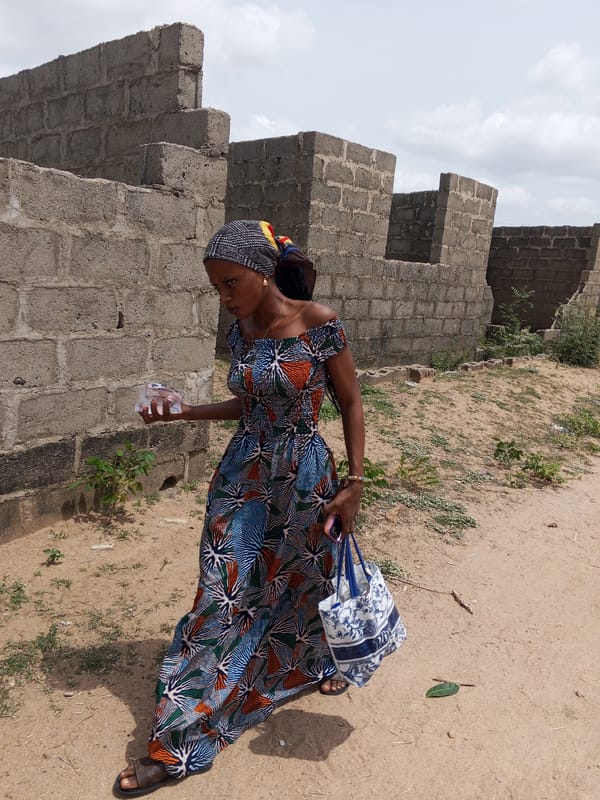 Woman in colorful dress spotted on Adonkolo dirt road