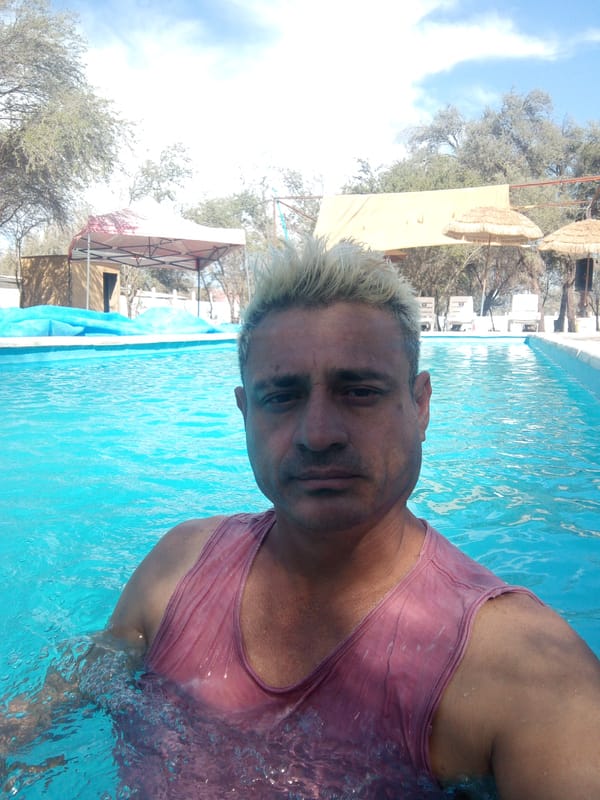 Man enjoys outdoor pool at recreational facility in Chile