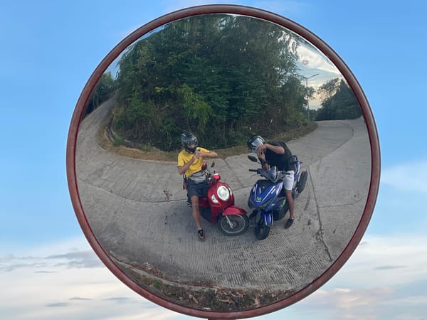Two motorcyclists meet on rural Thai road