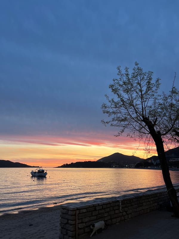 Child plays with bubbles near water in Montenegro