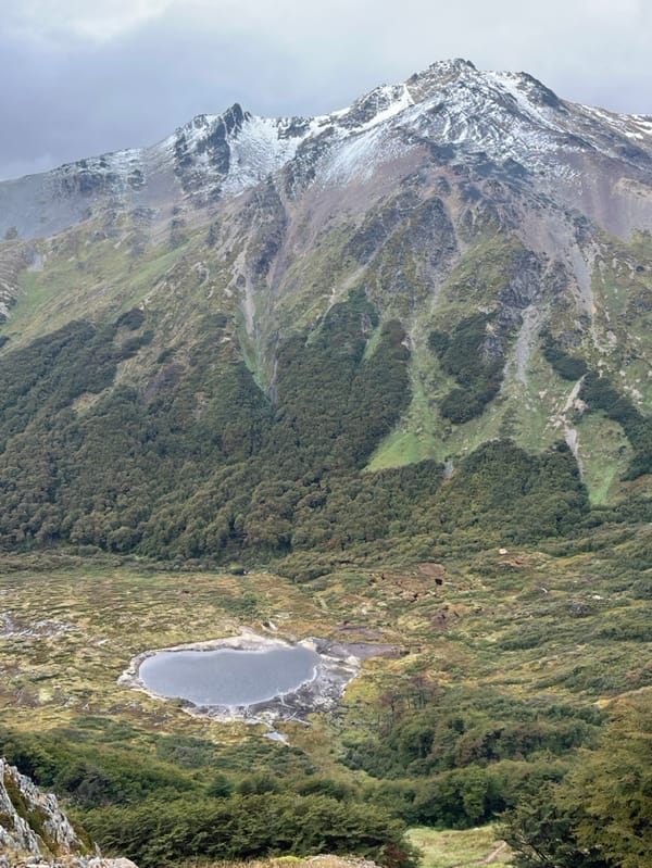 Tourist photographs mountain vista in Ushuaia, Argentina