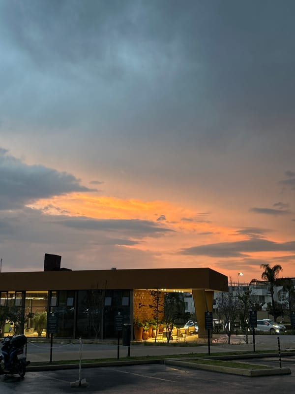 Man photographs dramatic sunset in Santa Clara Ocoyucan parking lot
