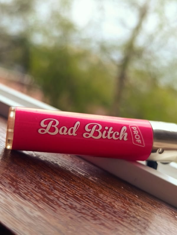 Pink lighter with text spotted on wooden surface in Bulgaria