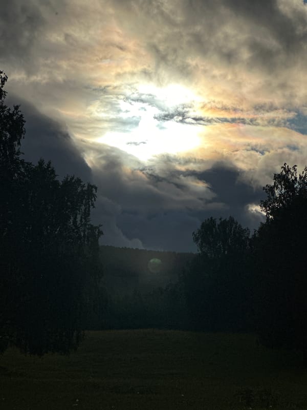 Woman documents countryside nature walk amid dramatic skies