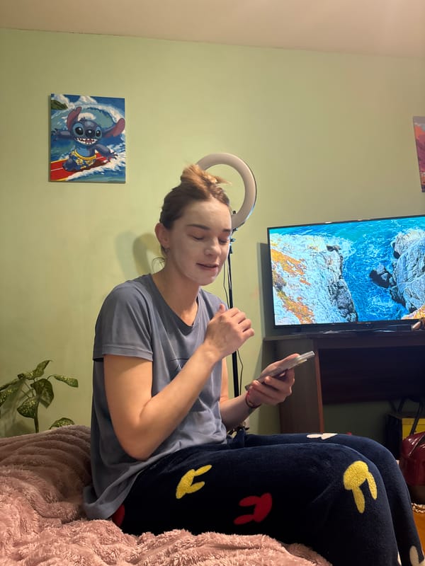 Person applies facial mask while using phone in Sinyavino