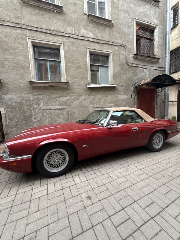 Vintage red Jaguar convertible parked in Saint Petersburg courtyard