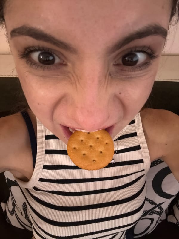 Woman eating cracker captured in casual moment in Varna