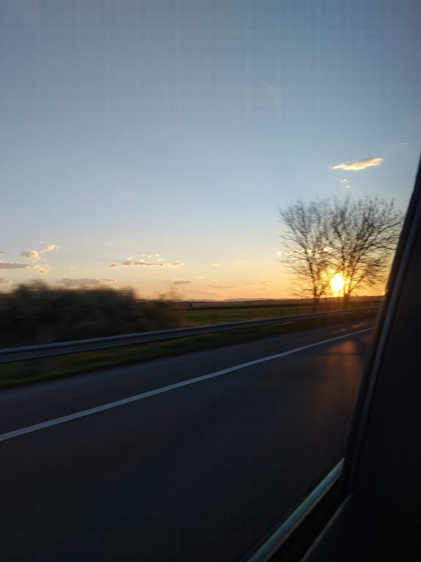 Sunset rural landscape viewed from car window in Belozem