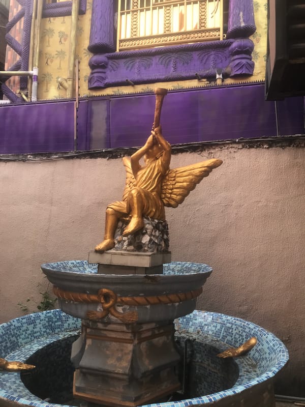 Ornate religious complex with golden angel fountain documented in Onitsha