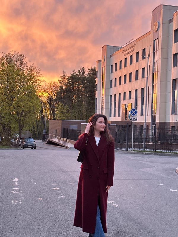 Woman observed near modern residential buildings in Ufa during golden hour